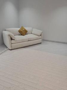 a white couch sitting in a living room at Quite and Cozy in Seeb