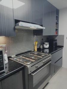 a kitchen with a stainless steel stove top oven at Quite and Cozy in Seeb