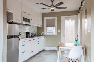a kitchen with white cabinets and a table and a ceiling at Eastern Market Carriage house efficiency PRIVACY in Washington, D.C.