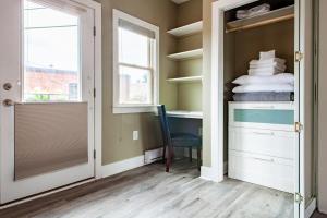 a room with a closet with a desk and a chair at Eastern Market Carriage house efficiency PRIVACY in Washington, D.C.