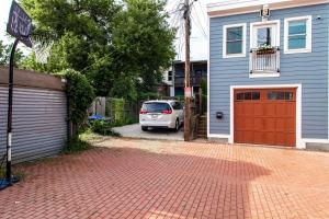 a car parked in front of a house with a basketball hoop at Eastern Market Carriage house efficiency PRIVACY in Washington, D.C.