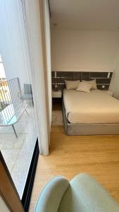 a bedroom with a bed and a window at Coruja’s House AL OPO in Porto