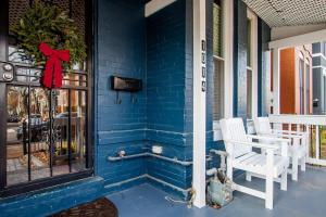 a blue house with two white chairs on a porch at NoMA 3BR Townhome - UnionMarket H St Streetcar in Washington, D.C.