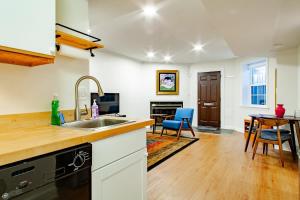 a kitchen with a sink and a table with chairs at A Classy Corner of DC Minutes walk to Dupont Circle in Washington, D.C.