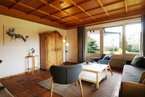 a living room with a table and chairs at Hus im Schwefelmättle, Hinterzarten in Hinterzarten