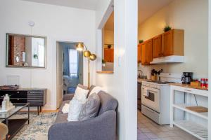 a kitchen and a living room with a couch and a table at Classy 1-BR Flat Nestled Between Dupont & Logan in Washington, D.C.
