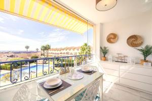 a dining room with a balcony with a view at PENTHOUSE BELLAVISTA with SEA VIEWS in Torrevieja