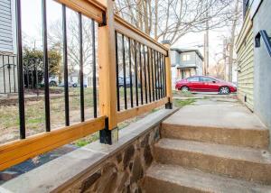 a porch with a wooden railing and a red car at Fantastic Falls Church HomeBase for DC area travel in Arlington