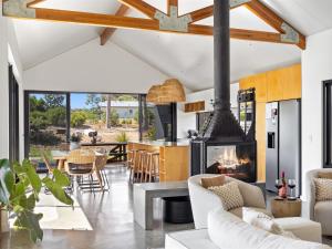 an open kitchen and living room with a fireplace at Casa Burnside in Margaret River Town