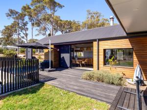 a modular home with a deck and an umbrella at Casa Burnside in Margaret River Town