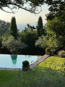 a swimming pool in the middle of a garden at Relais de Charme Villa Rossi Danielli in Viterbo