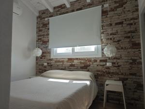 サンタンナ・アッレージにあるvilletta Fanny Porto Pinoのレンガの壁、ベッド付きのベッドルーム1室