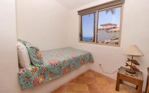 a bedroom with a bed and a window at Infinite views of Palmilla beach and East Cape in San José del Cabo +24 photos