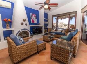 a living room with chairs and a fireplace at Infinite views of Palmilla beach and East Cape in San José del Cabo