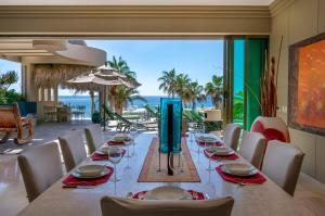 a dining room with a long table and a view of the ocean at Views to El Arco, Famous Cabo San Lucas bay rock formation in El Pueblito