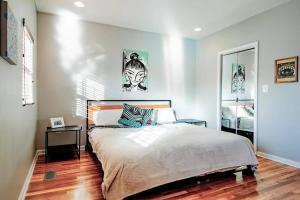 a bedroom with a large bed and a mirror at Family-friendly Home for travelers Near subway in Washington, D.C.