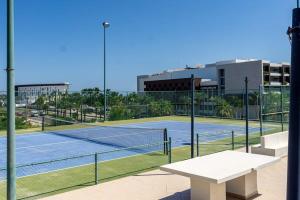 a tennis court with a bench on a tennis court at Villa Calafia Spacious Home w Private Tennis in Cabo San Lucas