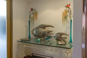 a glass shelf with two birds on it at Villa Calafia Spacious Home w Private Tennis in Cabo San Lucas