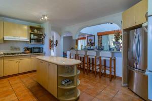 a kitchen with an archway in the middle of it at Villa Calafia Spacious Home w Private Tennis in Cabo San Lucas