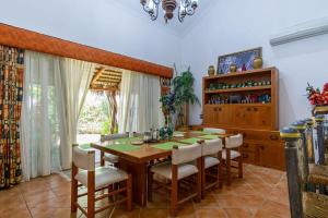 a dining room with a wooden table and chairs at Villa Calafia Spacious Home w Private Tennis in Cabo San Lucas
