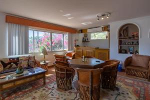 a living room with a table and chairs at Villa Calafia Spacious Home w Private Tennis in Cabo San Lucas