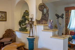 a room filled with lots of sculptures on display at Villa Calafia Spacious Home w Private Tennis in Cabo San Lucas