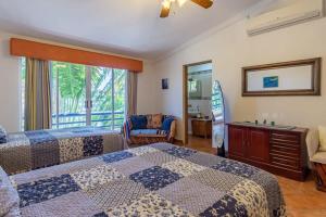 a hotel room with two beds and a window at Villa Calafia Spacious Home w Private Tennis in Cabo San Lucas