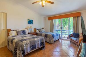 a hotel room with two beds and a balcony at Villa Calafia Spacious Home w Private Tennis in Cabo San Lucas +30 photos