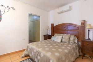 a bedroom with a bed and a dresser and a mirror at Villa Calafia Spacious Home w Private Tennis in Cabo San Lucas