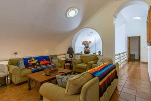 a living room with two couches and a table at Villa Calafia Spacious Home w Private Tennis in Cabo San Lucas