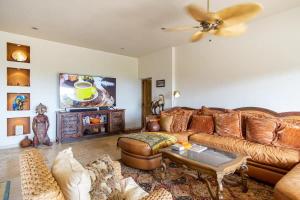 a living room with a couch and a tv at Las Terrazas Cerro Colorado in El Bedito