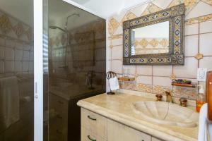 a bathroom with a sink and a mirror at Villa Calafia Spacious Home w Private Tennis in Cabo San Lucas