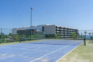 a tennis court in front of a building at Villa Calafia Spacious Home w Private Tennis in Cabo San Lucas