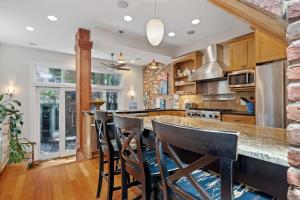 a kitchen with a large island with bar stools at Capitol Hill Homestay Convenient to H St in Washington, D.C.