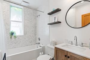 a bathroom with a sink toilet and a mirror at Capitol Hill Homestay Convenient to H St in Washington, D.C. +27 photos
