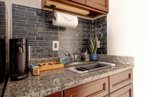 a kitchen with a sink and a counter top at Little Penthouse in Little Italy Near Inner Harbor Studio in Baltimore