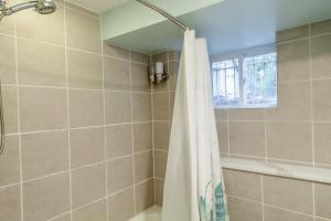 a bathroom with a shower and a shower curtain at Delightful 1-BR Accommodations Nearby METRO in Washington, D.C. +14 photos