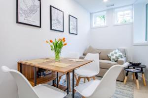a living room with a wooden table and white chairs at Bright & Cozy 1-BR Alcove in Bloomingdale in Washington, D.C.