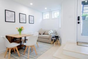 a living room with a table and white chairs at Bright & Cozy 1-BR Alcove in Bloomingdale in Washington, D.C.