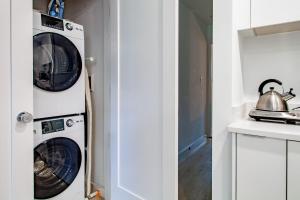 a kitchen with a washer and dryer in a room at Bright & Cozy 1-BR Alcove in Bloomingdale in Washington, D.C.