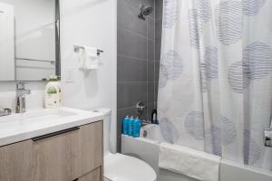 a bathroom with a shower and a toilet and a sink at Bright & Cozy 1-BR Alcove in Bloomingdale in Washington, D.C.