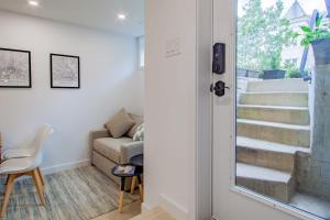 a living room with a couch and a stairway at Bright & Cozy 1-BR Alcove in Bloomingdale in Washington, D.C.