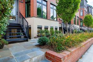 a brick building with stairs and plants in front of it at Bright & Cozy 1-BR Alcove in Bloomingdale in Washington, D.C.
