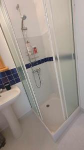 a shower with a glass door in a bathroom at Les chambres de Solol in Félines
