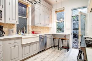 a kitchen with white cabinets and two stools at LUXE Kalorama 5-BR Townhome Close to Dupont Circle in Washington, D.C.