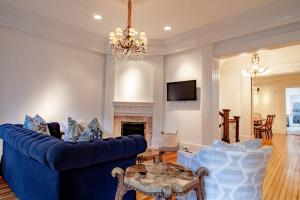 a living room with a blue couch and a table at LUXE Kalorama 5-BR Townhome Close to Dupont Circle in Washington, D.C.