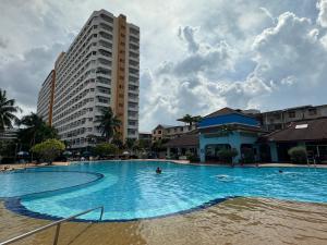 a large swimming pool in front of a tall building at Mina view condo 12 in Pattaya South