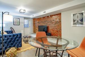 a living room with a glass table and a brick wall at 2-BR Petworth Pad Walk to METRO Subway in Washington, D.C.