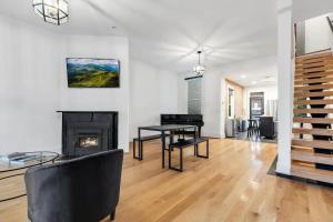 a living room with a fireplace and a table at H St DC Haven 4-BR Homestay in Washington, D.C.
