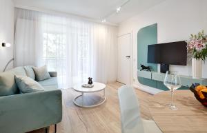 a living room with a couch and a table at Premium City Apartments in Bydgoszcz